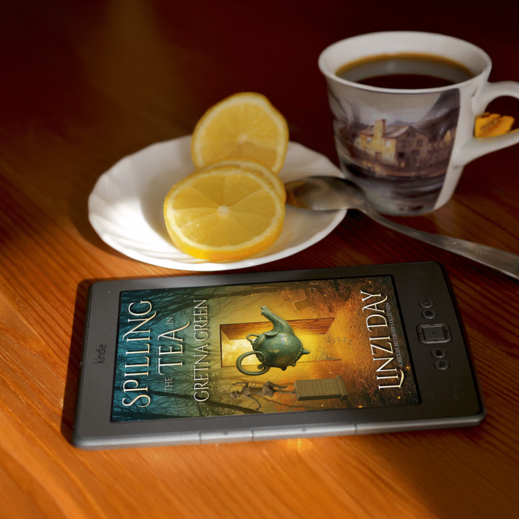 Spilling the Tea on a Kindle with a cup of tea in the background.