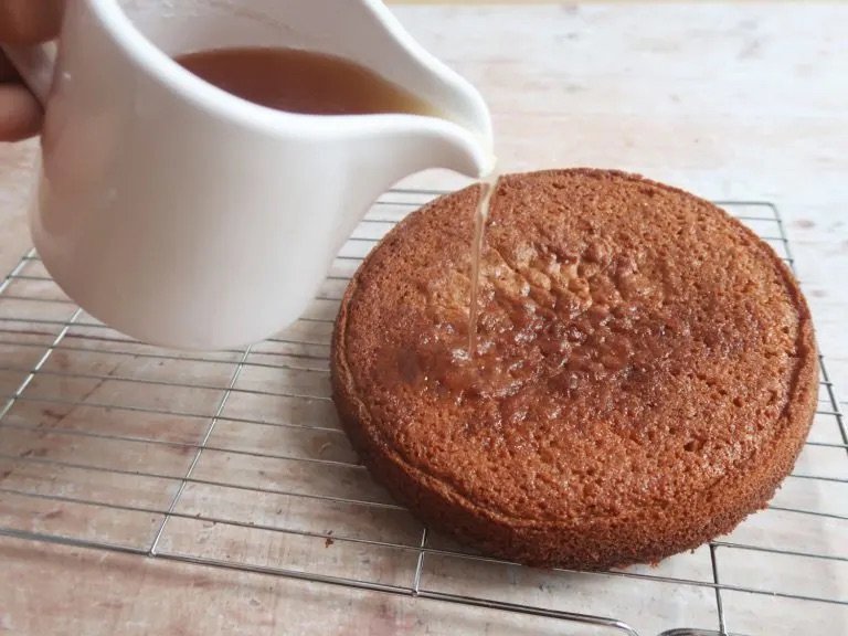 Adding the honey syrup to the Galician Honey Cake